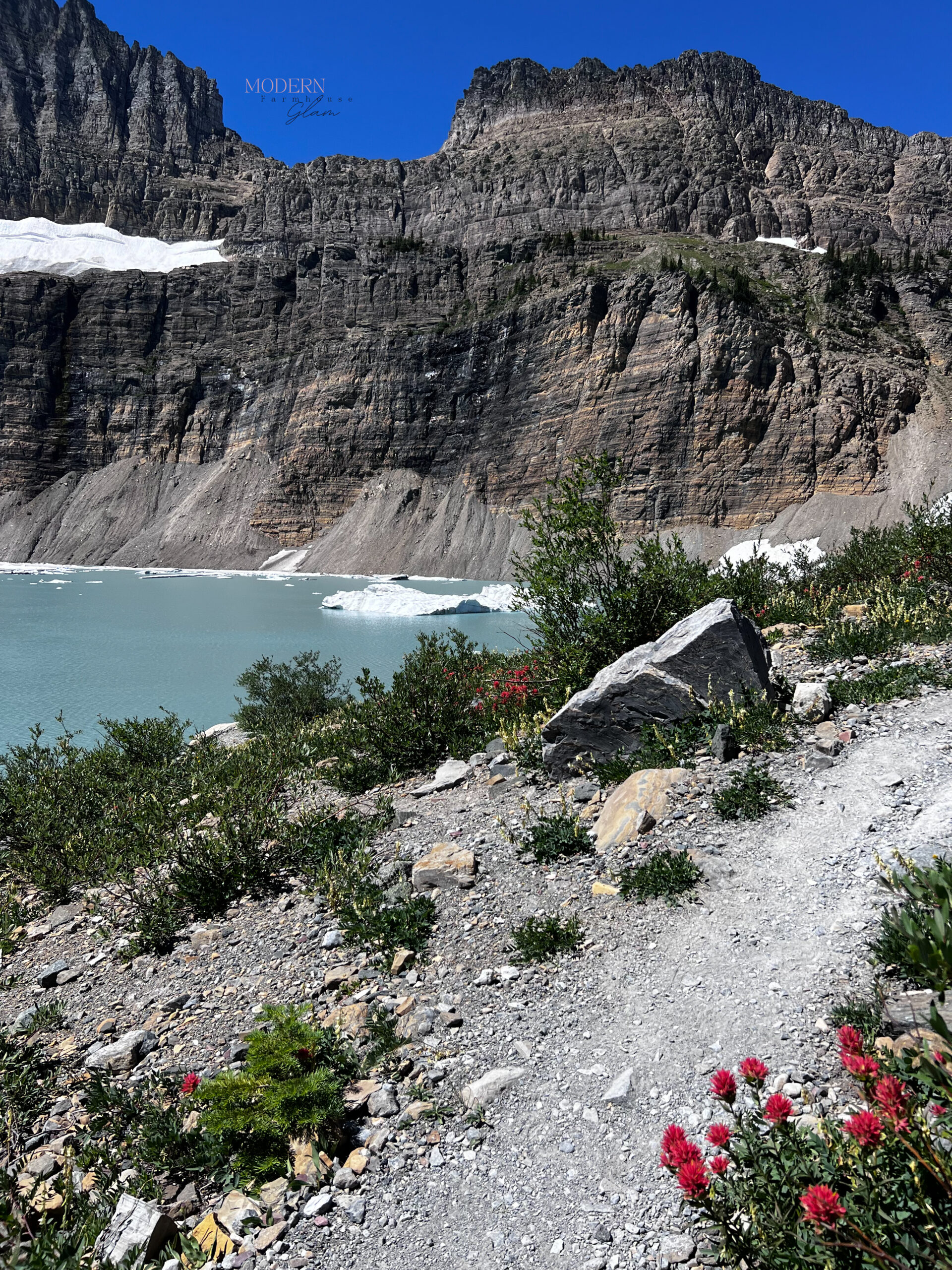 I love the contrast of the red wildflowers with the icy clue water of Grinell Glacier