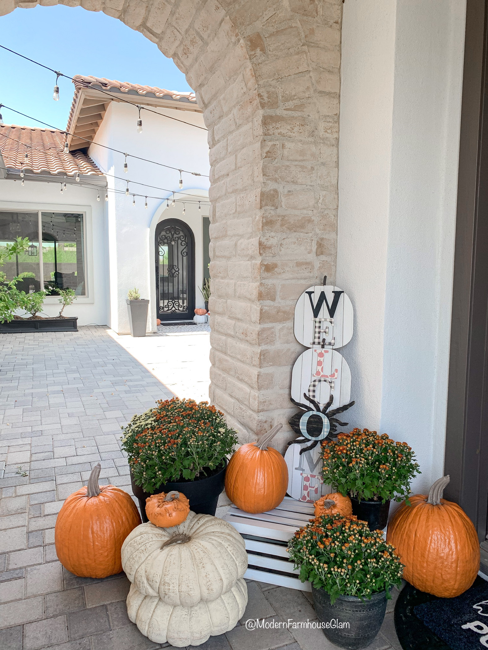 Fall porch with faux pumpkins LTK